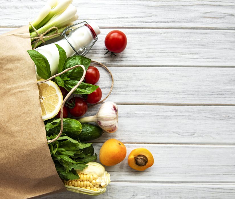 Healthy food background. Healthy  food in paper bag, vegetables and fruits.  Shopping food supermarket and clean vegan eating concept.
